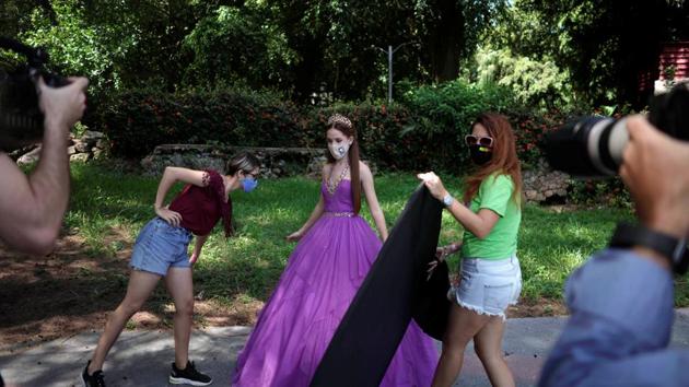 Thaidelen Gonzalez poses during a photo session for her quinceanera (coming of age of 15-year-olds) celebration amid coronavirus disease (Covid-19) spread concerns, in Havana, Cuba. (REUTERS/Alexandre Meneghini)