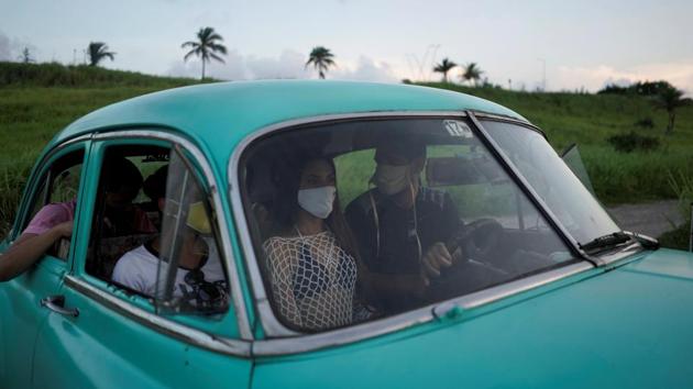 Estefani Linares rides inside a vintage car after a photo session for her quinceanera (coming of age of 15-year-olds) celebration. (REUTERS/Alexandre Meneghini)