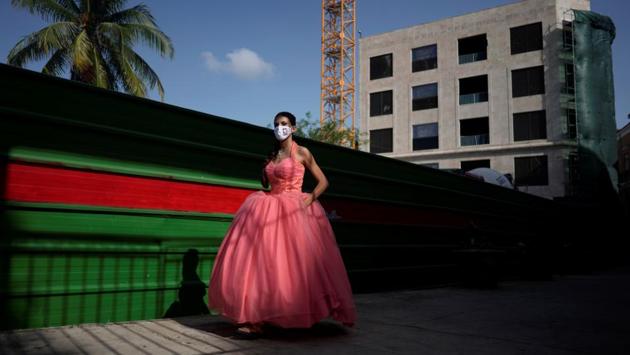 Estefani Linares poses during a photo session for her quinceanera (coming of age of 15-year-olds) celebration amid coronavirus disease. (REUTERS/Alexandre Meneghini)