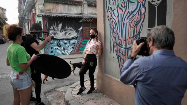Thaidelen Gonzalez poses during a photo session for her quinceanera celebration amid coronavirus disease. (REUTERS/Alexandre Meneghini)