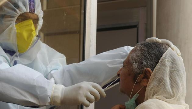 A health worker collects a swab sample from a woman to test for coronavirus infection, at Tourist Reception Centre, in Srinagar, Jammu and Kashmir on Monday.(Waseem Andrabi/HT Photo) A health worker collects a swab sample from a woman to test for coronavirus infection, at Tourist Reception Centre, in Srinagar, Jammu and Kashmir on Monday.(Waseem Andrabi/HT Photo)