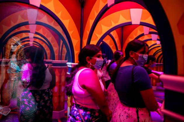 People walk through a house of mirrors attraction in Niagara Falls, Ontario, Canada July 21, 2020. (REUTERS) People walk through a house of mirrors attraction in Niagara Falls, Ontario, Canada July 21, 2020. (REUTERS)