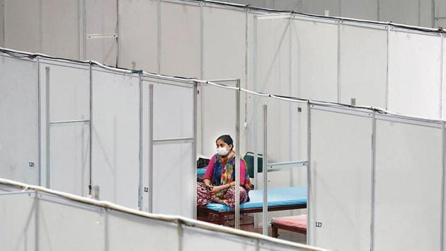 A woman sits on her bed inside a care centre for the coronavirus disease patients at an indoor sports complex in New Delhi.(Reuters) A woman sits on her bed inside a care centre for the coronavirus disease patients at an indoor sports complex in New Delhi.(Reuters)