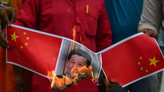 People burn posters and effigy of Chinese President Xi Jinping during an anti-China protest in Allahabad.(AFP File)