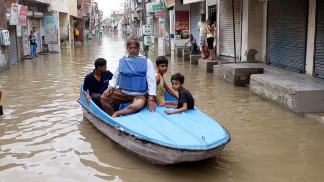 Vijay Kumar Sharma, a former councillor and resident of Parasram Nagar, riding a pedal boat along with local residents on streets of the locality to highlight the problem of waterlogging due to lack of proper drainage every monsoon. (Sanjeev Kumar/HT) Vijay Kumar Sharma, a former councillor and resident of Parasram Nagar, riding a pedal boat along with local residents on streets of the locality to highlight the problem of waterlogging due to lack of proper drainage every monsoon. (Sanjeev Kumar/HT)