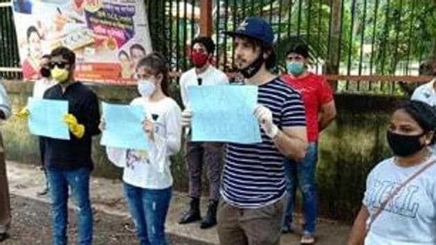 Zaan Khan protests outside the building of a producer demanding payments. Zaan Khan protests outside the building of a producer demanding payments.