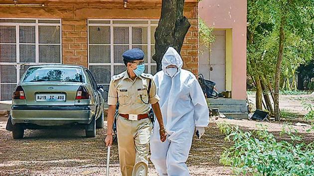 An ED official wearing a PPE suit raids the farmhouse and residence of Agrasain Gehlot, brother of CM Ashok Gehlot.(PTI)