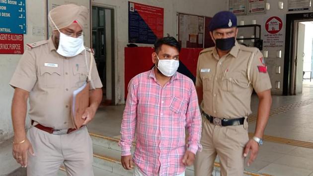 The accused in police custody in Sector 17, Chandigarh, on Thursday. (HT Photo) The accused in police custody in Sector 17, Chandigarh, on Thursday. (HT Photo)
