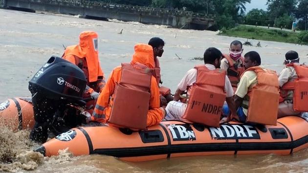 National Disaster Respond Force (NDRF) personnel rescue villagers from flood-affected areas in Goalpara district on July 20. According to ANI reports, the State Disaster Response Fund (SDRF), National Disaster Response Fund (NDRF), Circle Offices and locals have rescued 452 people so far. (ANI)