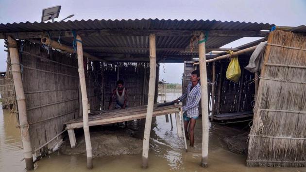 A villager works inside his damaged house in a flood affected area, in Darrang district on July 21. The floods in Assam have so far claimed 89 lives, ASDMA told PTI. (PTI)