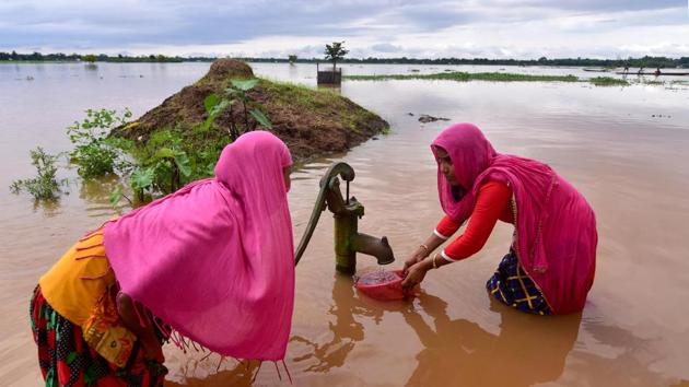Women fetch drinking water from a hand pump in a flood affected area at Madhabpara village on July 22. The same day, central government announced that it would release rupees 346 crores, in phase 1, under the Flood Management Program (FMP) scheme to Assam and will also hold talks with Bhutan to solve the recurring flood problem in the lower parts of the state. (PTI)