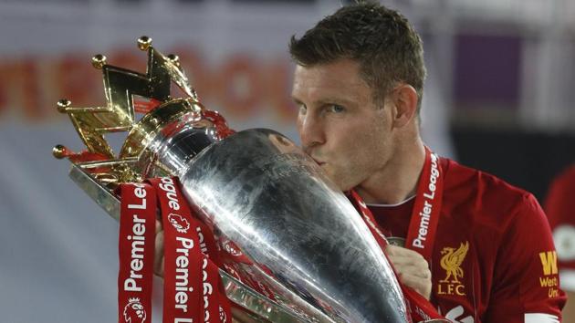 Liverpool's James Milner kisses the English Premier League trophy. (AP)