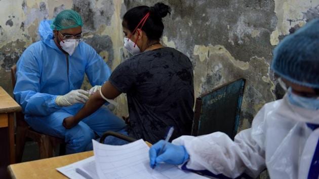 BMC health workers collect plasma samples from patients in Dharavi who recovered from Covid-19 in Mumbai on July 23. Maharashtra recorded 74,647 confirmed Covid-19 cases and 2,855 fatalities during the lockdown between March 24 and June 3. Since the relaxations were gradually lifted, while keeping the lockdown intact, the state has registered almost quadrupled both those figures. (Satish Bate / HT Photo)