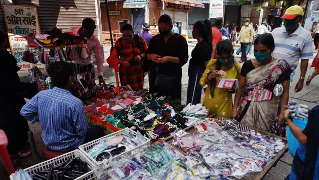 Residents of Thane city out buying face masks during lockdown relaxation on July 22. After the unlocking of activities, cases shot up in parts of MMR, Pune, Nashik, Aurangabad and Solapur districts. “There are no projections but looking at the trend today, the cases are expected to rise till August after which we can probably see the cases plateau,” Anup Kumar Yadav, health commissioner of Maharashtra told HT. (Praful Gangurde / HT Photo)