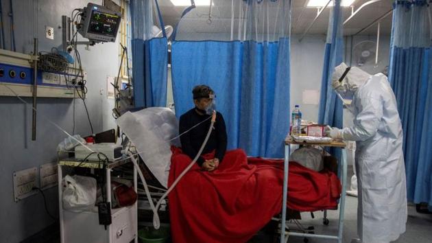 A medical worker tends to a Covid-19 patient at Lok Nayak Jai Prakash Hospital, New Delhi, July 17(REUTERS)