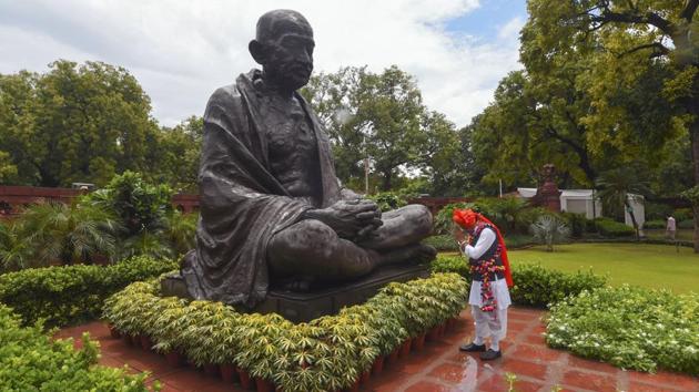 Newly elected Rajya Sabha member Sumer Singh Solanki pays tribute to Mahatma Gandhi after taking oath, at Parliament House in New Delhi on July 22. Prime Minister Narendra Modi also held an interaction with BJP MPs, who were administered oath in the ceremony. (Shahbaz Khan / PTI)
