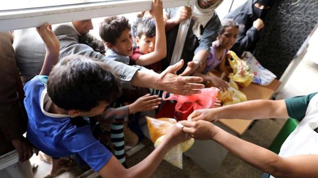People crowd to get food rations from a charity kitchen in Sanaa, Yemen(REUTERS) People crowd to get food rations from a charity kitchen in Sanaa, Yemen(REUTERS)