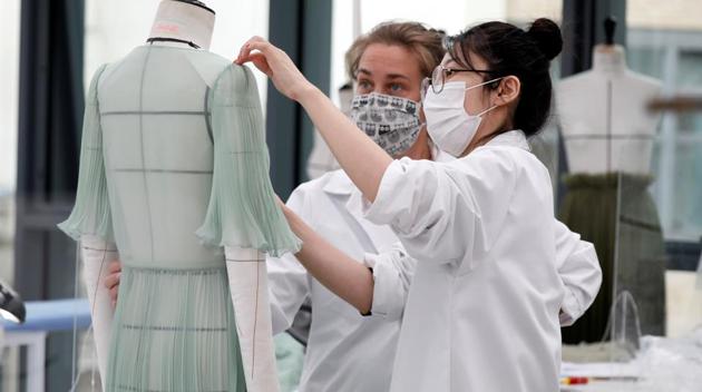 Dressmakers, wearing protective masks, work ahead of Dior's 2021 Cruise collection presentation by designer Maria Grazia Chiuri at the Dior fashion house workshop in Paris. (REUTERS/Charles Platiau) Dressmakers, wearing protective masks, work ahead of Dior's 2021 Cruise collection presentation by designer Maria Grazia Chiuri at the Dior fashion house workshop in Paris. (REUTERS/Charles Platiau)