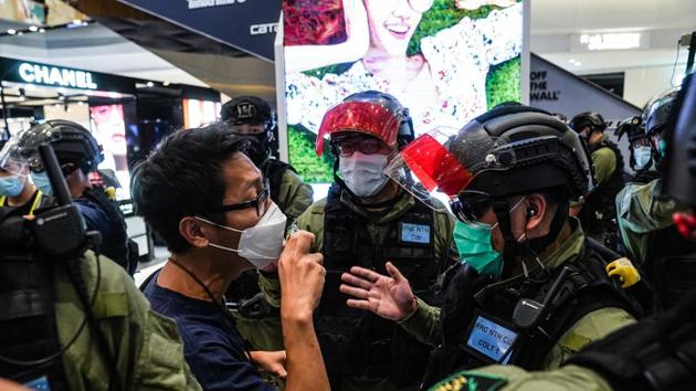 Riot police argue with Ng Kin Wai, a pro-democracy activist, during a protest to mark the one-year anniversary of a mob attack on protesters and subway passengers in Hong Kong on July 21, 2020. (Bloomberg Photo) Riot police argue with Ng Kin Wai, a pro-democracy activist, during a protest to mark the one-year anniversary of a mob attack on protesters and subway passengers in Hong Kong on July 21, 2020. (Bloomberg Photo)