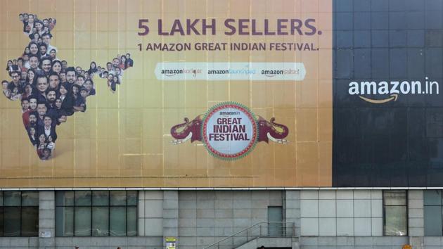 People move past a hoarding of Amazon India outside a metro rail station in New Delhi. (REUTERS) People move past a hoarding of Amazon India outside a metro rail station in New Delhi. (REUTERS)