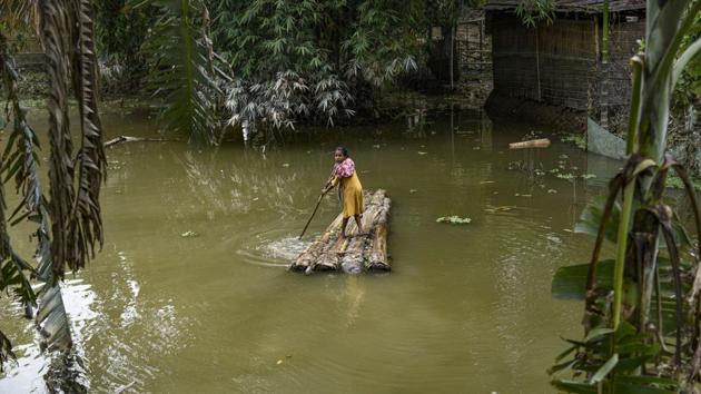 A woman rows a makeshift raft to cross a flood-affected area in Morigaon district of Assam on July 20. According to the flood report by the Assam State Disaster Management Authority (ASDMA), nearly 2,631,343 people have been severely affected by the floods, with Barpeta, Dibrugarh, Kokrajhar, Bongaigaon, Tinsukia being the most affected districts. (PTI)
