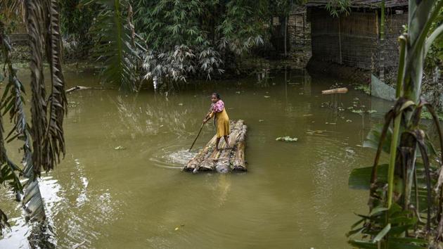 Morigaon: A village girl rows a makeshift raft to cross a flood-affected area in Morigaon district of Assam.(PTI) Morigaon: A village girl rows a makeshift raft to cross a flood-affected area in Morigaon district of Assam.(PTI)