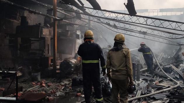 Firefighters dousing the flames at the plastic manufacturing unit on Friday. (HT Photo) Firefighters dousing the flames at the plastic manufacturing unit on Friday. (HT Photo)