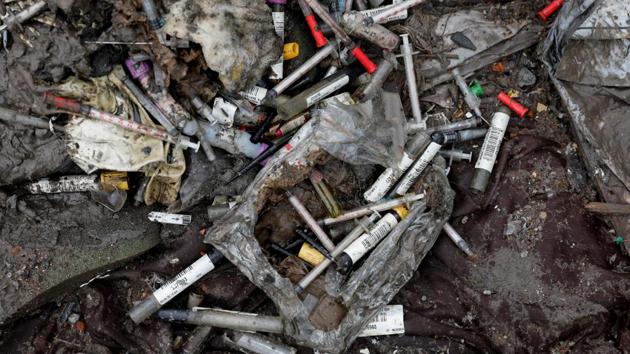 Discarded syringes lie amongst other bits of disposed medical waste at a landfill site, during the coronavirus disease (Covid-19) outbreak, in New Delhi. (REUTERS) Discarded syringes lie amongst other bits of disposed medical waste at a landfill site, during the coronavirus disease (Covid-19) outbreak, in New Delhi. (REUTERS)