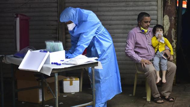 A member of the BMC medical staff during a screening and swab test of residents in Dadar (West) in Mumbai on July 23. Nearly 78% of the state’s total cases have been recorded after lockdown restrictions were lifted in June as part of ‘Mission Begin Again’. State officials told HT, the number of patients and toll could have been higher had it not been for timely lockdown, travel restrictions, social distancing, and other interventions. (Anshuman Poyrekar / HT Photo)