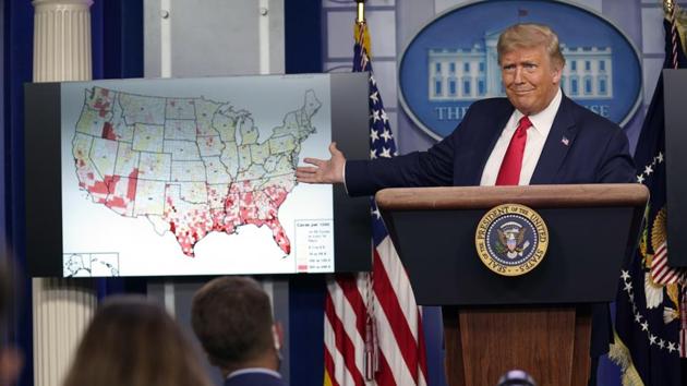 US President Donald Trump gestures towards a graphic on the coronavirus outbreak as he speaks during a news conference at the White House, in Washington on July 23. Trump has been reluctant to wear a mask himself but this week he encouraged Americans to wear masks and recently appeared in public for the first time with a face covering. (Evan Vucci / AP) US President Donald Trump gestures towards a graphic on the coronavirus outbreak as he speaks during a news conference at the White House, in Washington on July 23. Trump has been reluctant to wear a mask himself but this week he encouraged Americans to wear masks and recently appeared in public for the first time with a face covering. (Evan Vucci / AP)