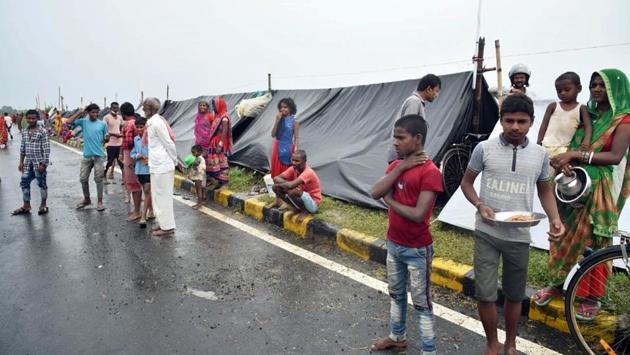 Flood-affected people take shelter on a highway road while waiting for help in Darbhanga on July 22. “We will have to stay here till our area remains flooded. We don’t have food. No one from the administration has come yet. Everything has submerged and the water levels are increasing constantly.” Nandu Kumar, a local resident told ANI. (ANI) Flood-affected people take shelter on a highway road while waiting for help in Darbhanga on July 22. “We will have to stay here till our area remains flooded. We don’t have food. No one from the administration has come yet. Everything has submerged and the water levels are increasing constantly.” Nandu Kumar, a local resident told ANI. (ANI)