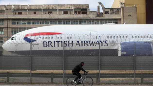 British Airways is among the carriers announcing dismissals and unpaid leave programs.(Bloomberg File Photo)