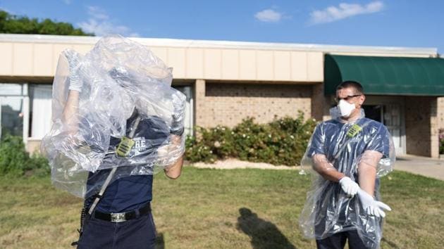 Firefighters put on protective gear while responding to a 911 medical call for a person experiencing Covid-19 related symptoms in Brooklyn Park, Maryland on July 21. According to a Reuters tally, the United States is recording 2,600 new cases every hour on average, the highest rate in the world. (Alex Edelman / Bloomberg) Firefighters put on protective gear while responding to a 911 medical call for a person experiencing Covid-19 related symptoms in Brooklyn Park, Maryland on July 21. According to a Reuters tally, the United States is recording 2,600 new cases every hour on average, the highest rate in the world. (Alex Edelman / Bloomberg)