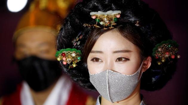 Models present creations during a fashion show, wearing masks as a measure to avoid the spread of the coronavirus disease (COVID-19), in Seoul, South Korea July 24, 2020. (REUTERS)
