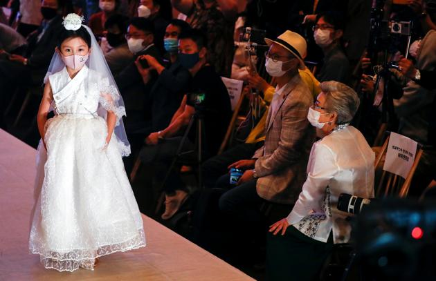 A child model presents a creation during a fashion show, wearing a mask as a measure to avoid the spread of the coronavirus disease (COVID-19), in Seoul, South Korea July 24, 2020. (REUTERS)