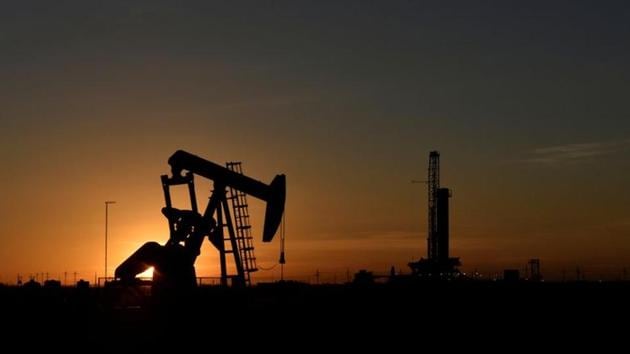 A pump jack operates in front of a drilling rig at sunset in an oil field in Midland, Texas US(Reuters File Photo)