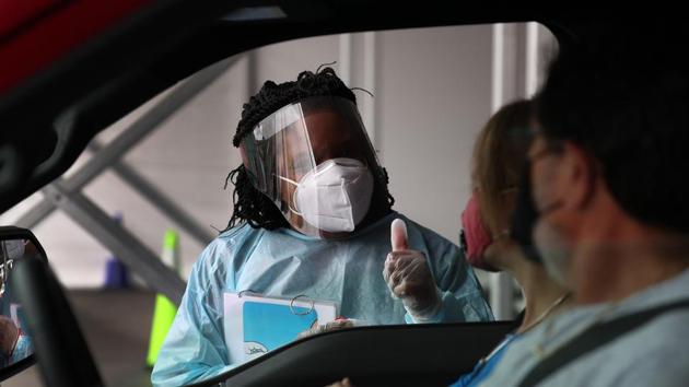 A health care worker gives a thumbs up after people used nasal swabs for a self administered test at the new federally funded COVID-19 testing site at the Miami-Dade County Auditorium in Miami, Florida on July 23. Infections in the United States have rapidly accelerated since the first case was detected on Jan. 21. It took the country 98 days to reach 1 million cases. (Joe Raedle / Getty Images / AFP) A health care worker gives a thumbs up after people used nasal swabs for a self administered test at the new federally funded COVID-19 testing site at the Miami-Dade County Auditorium in Miami, Florida on July 23. Infections in the United States have rapidly accelerated since the first case was detected on Jan. 21. It took the country 98 days to reach 1 million cases. (Joe Raedle / Getty Images / AFP)