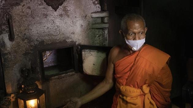 A Buddhist monk talks to media after putting the coffin of the infamous Si Ouey into an incinerator for cremation at Wat Bang Phraek Tai temple Nonthaburi province, Thailand.(AP Photo/Sakchai Lalit)