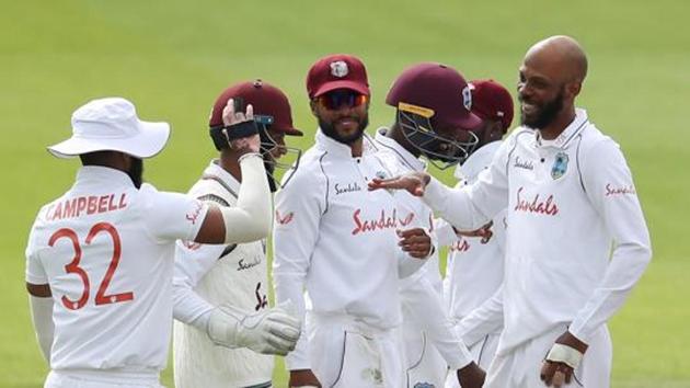 West Indies' Roston Chase celebrates taking the wicket of England's Rory Burns, caught by West Indies' Rakheem Cornwall with teammates (REUTERS) West Indies' Roston Chase celebrates taking the wicket of England's Rory Burns, caught by West Indies' Rakheem Cornwall with teammates (REUTERS)