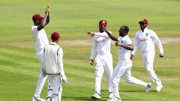 West Indies' Kemar Roach celebrates taking the wicket of England's Ben Stokes with Jason Holder and teammates, as play resumes behind closed doors following the outbreak of the coronavirus disease.(REUTERS) West Indies' Kemar Roach celebrates taking the wicket of England's Ben Stokes with Jason Holder and teammates, as play resumes behind closed doors following the outbreak of the coronavirus disease.(REUTERS)