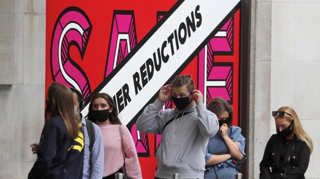 Shoppers wear face coverings to protect themselves from Covid-19 as they queue at a shop in London, Friday, July 24, 2020. (AP) Shoppers wear face coverings to protect themselves from Covid-19 as they queue at a shop in London, Friday, July 24, 2020. (AP)