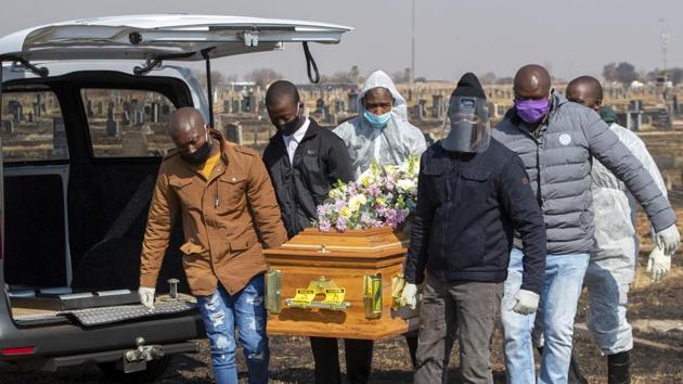 Family members and funeral workers in a protective gear carry the coffin of a COVID-19 victim in Thokoza on July 23. South Africa witnessed 17,000 extra deaths from natural causes or 59% more than would normally be expected between early May and mid-July, scientists said, suggesting many more people are dying of COVID-19 than shown in official figures, Reuters reported. (Themba Hadebe / AP) Family members and funeral workers in a protective gear carry the coffin of a COVID-19 victim in Thokoza on July 23. South Africa witnessed 17,000 extra deaths from natural causes or 59% more than would normally be expected between early May and mid-July, scientists said, suggesting many more people are dying of COVID-19 than shown in official figures, Reuters reported. (Themba Hadebe / AP)