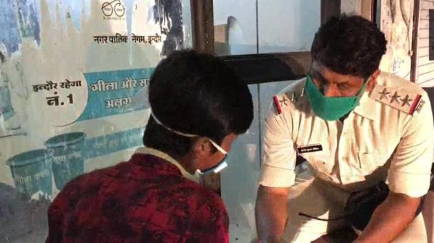 Vinod Dikshit, a Station House Officer (SHO) from Palasia, Indore teaching the young boy Maths and English.(ANI)