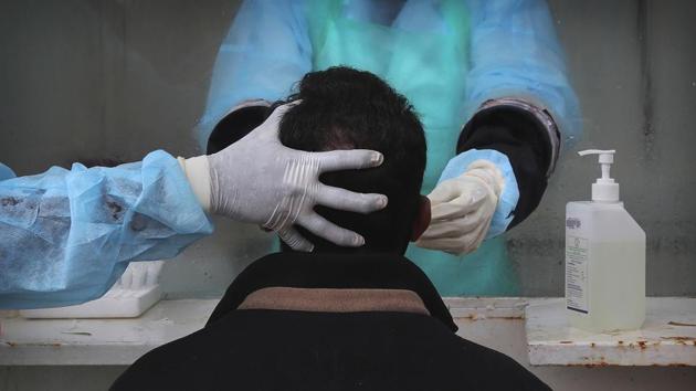 A person has a nasal swab sample taken for COVID-19 testing at Government Fever Hospital in Hyderabad on July 23. For the first time since the pandemic hit, a record number of over 4.4 lakh Covid-19 tests have been conducted in a single day, data by the Indian Council of Medical Research shows for July 25. (AP) A person has a nasal swab sample taken for COVID-19 testing at Government Fever Hospital in Hyderabad on July 23. For the first time since the pandemic hit, a record number of over 4.4 lakh Covid-19 tests have been conducted in a single day, data by the Indian Council of Medical Research shows for July 25. (AP)