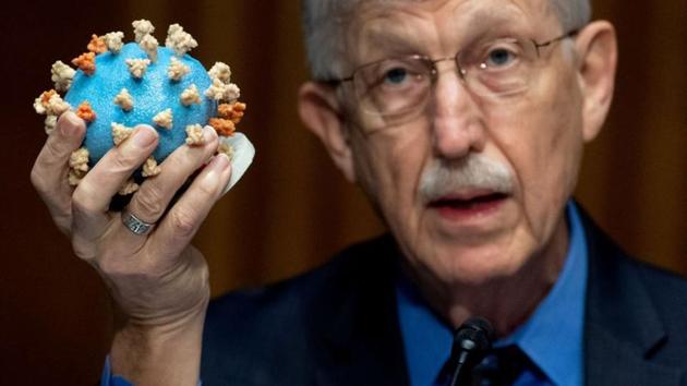 Dr Francis Collins, director of the National Institutes of Health (NIH), holds up a model of SARS-CoV-2, known as the novel coronavirus.(REUTERS)