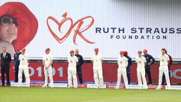 England players wear red caps for the Ruth Strauss Foundation day before the start of the play of the first day. (AP)