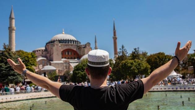 A worshipper gestures towards the Hagia Sophia Grand Mosque, during the opening ceremony in Istanbul on July 24. “We are ending our 86 years of longing today,” Sait Colak, a devotee told Reuters, referring to the nearly nine decades since Hagia Sophia was declared a museum and ceased to be a place of worship. (Kerem Uzel / Bloomberg) A worshipper gestures towards the Hagia Sophia Grand Mosque, during the opening ceremony in Istanbul on July 24. “We are ending our 86 years of longing today,” Sait Colak, a devotee told Reuters, referring to the nearly nine decades since Hagia Sophia was declared a museum and ceased to be a place of worship. (Kerem Uzel / Bloomberg)