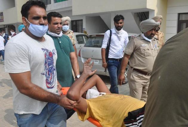 Gangster John Buttar being taken away by the police at Aman Homes near Jalvayu Vihar in Sunny Enclave, Kharar, on Friday. (Gurminder Singh/HT) Gangster John Buttar being taken away by the police at Aman Homes near Jalvayu Vihar in Sunny Enclave, Kharar, on Friday. (Gurminder Singh/HT)