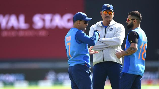 India captain Virat Kohli (r) chats with coach Ravi Shastri (c) and MS Dhoni before the Group Stage match of the ICC Cricket World Cup 2019 between India and Afghanistan at The Ageas Bowl.(IDI via Getty Images)