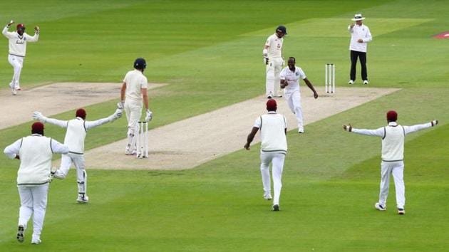 West Indies' Kemar Roach celebrates taking the wicket of England's Dom Sibley lbw with teammates. (REUTERS)